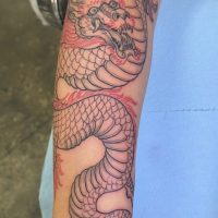 Explore our dragon linework tattoo by Tiny, showcasing precise artistry and mythical inspiration at The Wolves Den. Dragon linework tattoo by Tiny at The Wolves Den Pakenham.