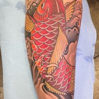 Explore our realistic Japanese Koi fish tattoo by Tiny, capturing exquisite detail and cultural significance at The Wolves Den. Realistic Japanese Koi fish tattoo by Tiny at The Wolves Den Pakenham.